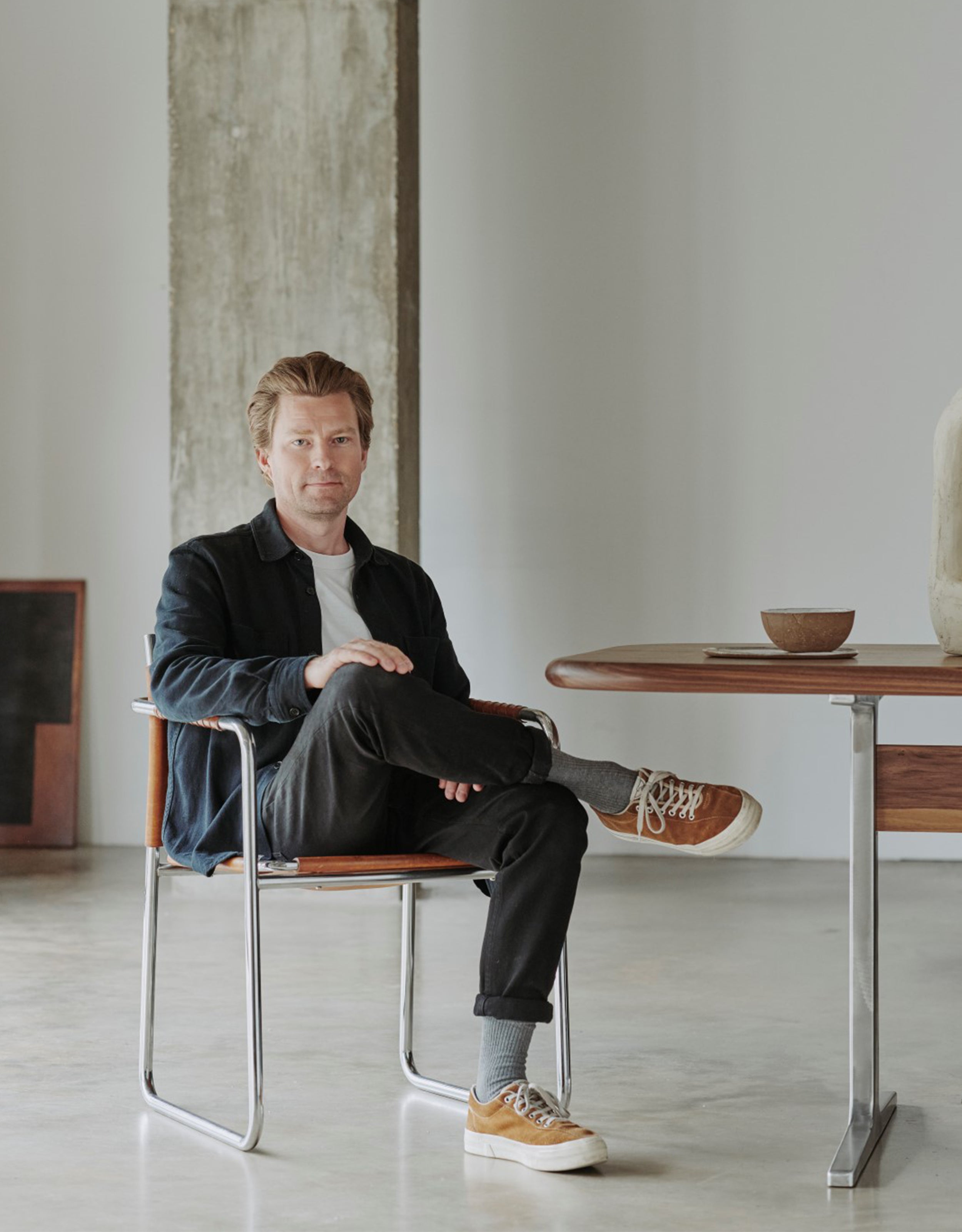 Portrait of designer Magnus Pettersen sitting on a chair.