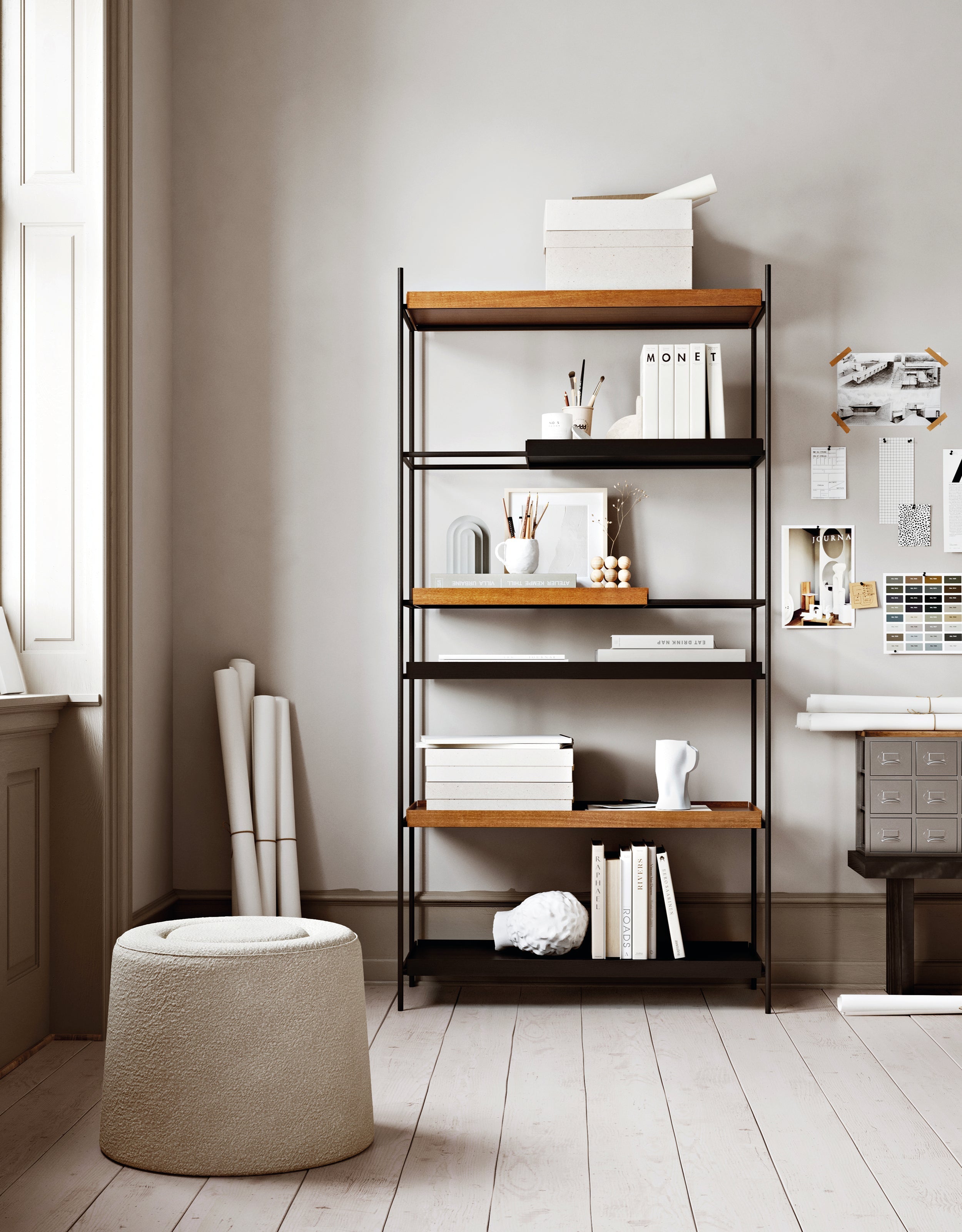 Open shelving system with a black metal frame and shelves in black and walnut, placed in a creative workspace