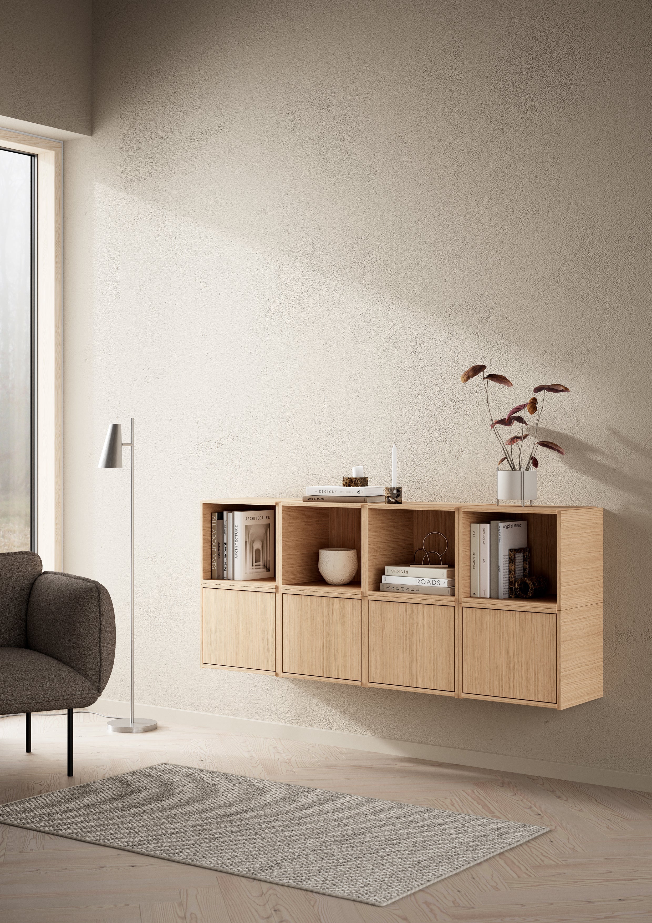 Wall-mounted modular oak storage system with books, with rug in front, lit by sunlight.