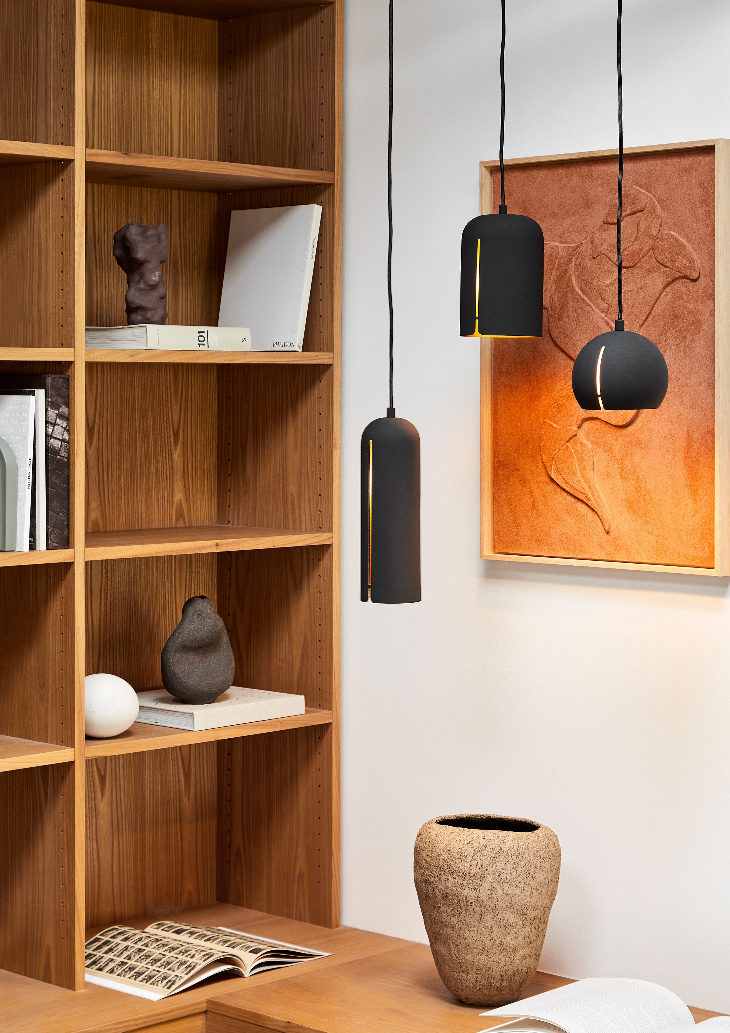 Cluster of minimalistic black pendants with brass coloured inner.