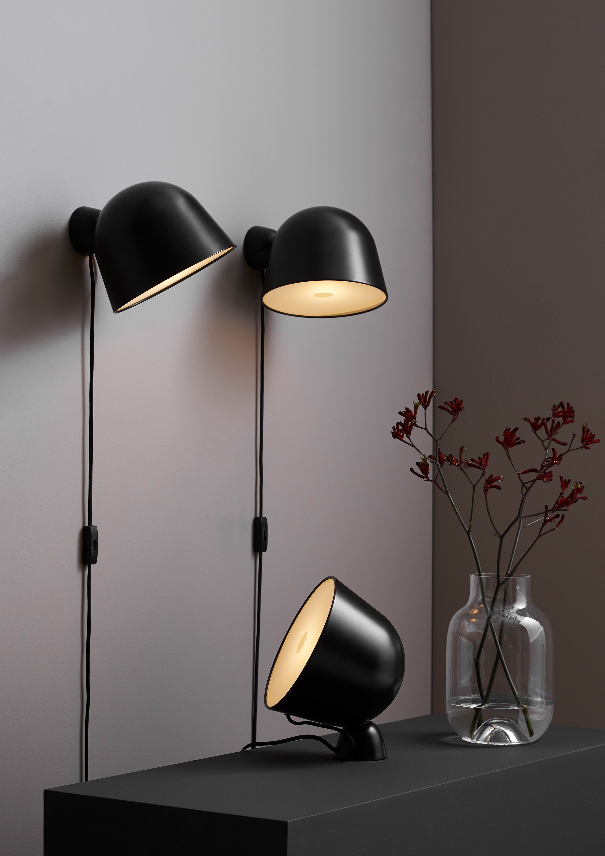 Black painted metal wall lamp with adjustable shade.