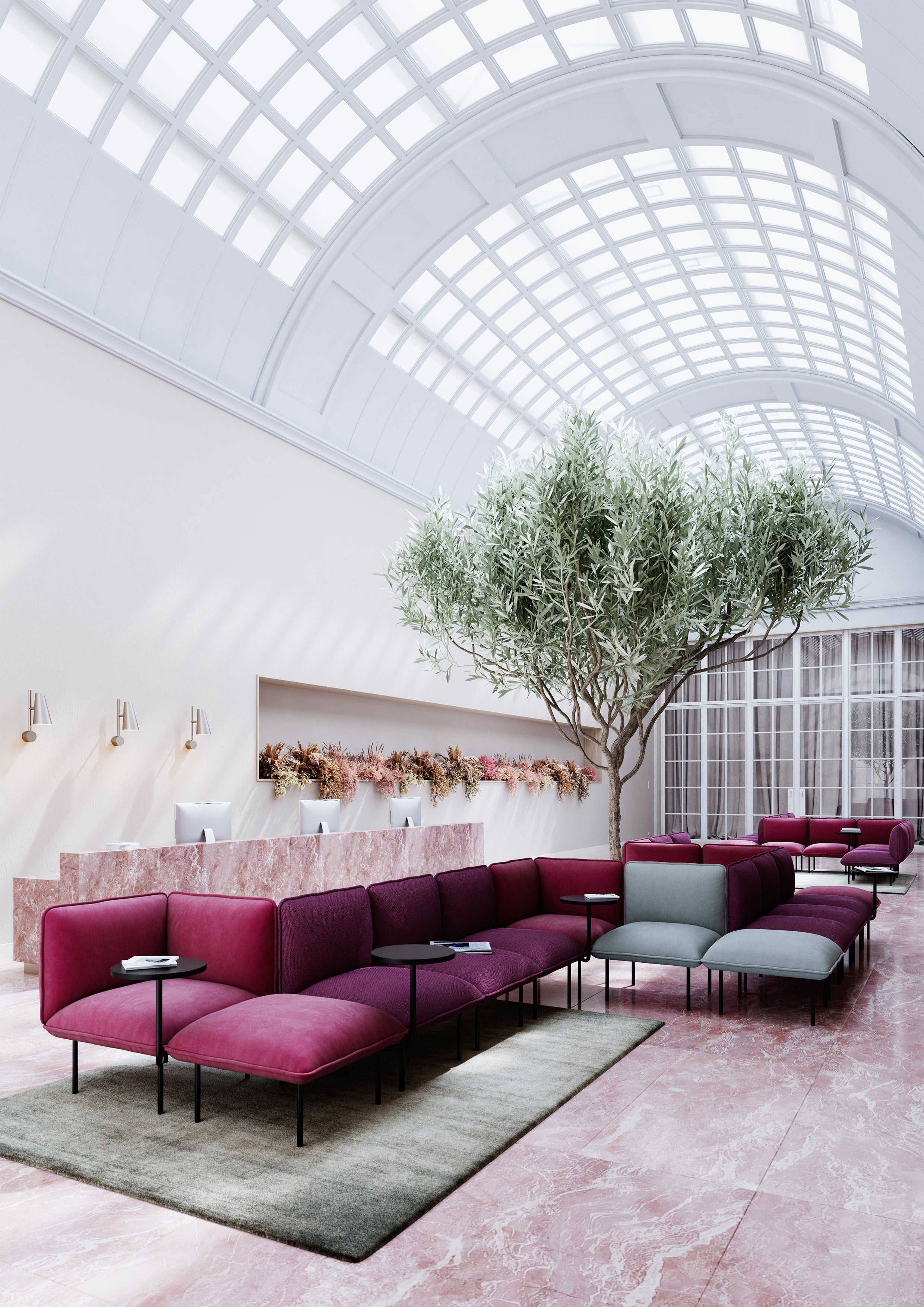 Large multicolored modular sofa placed in a bright hotel lobby.