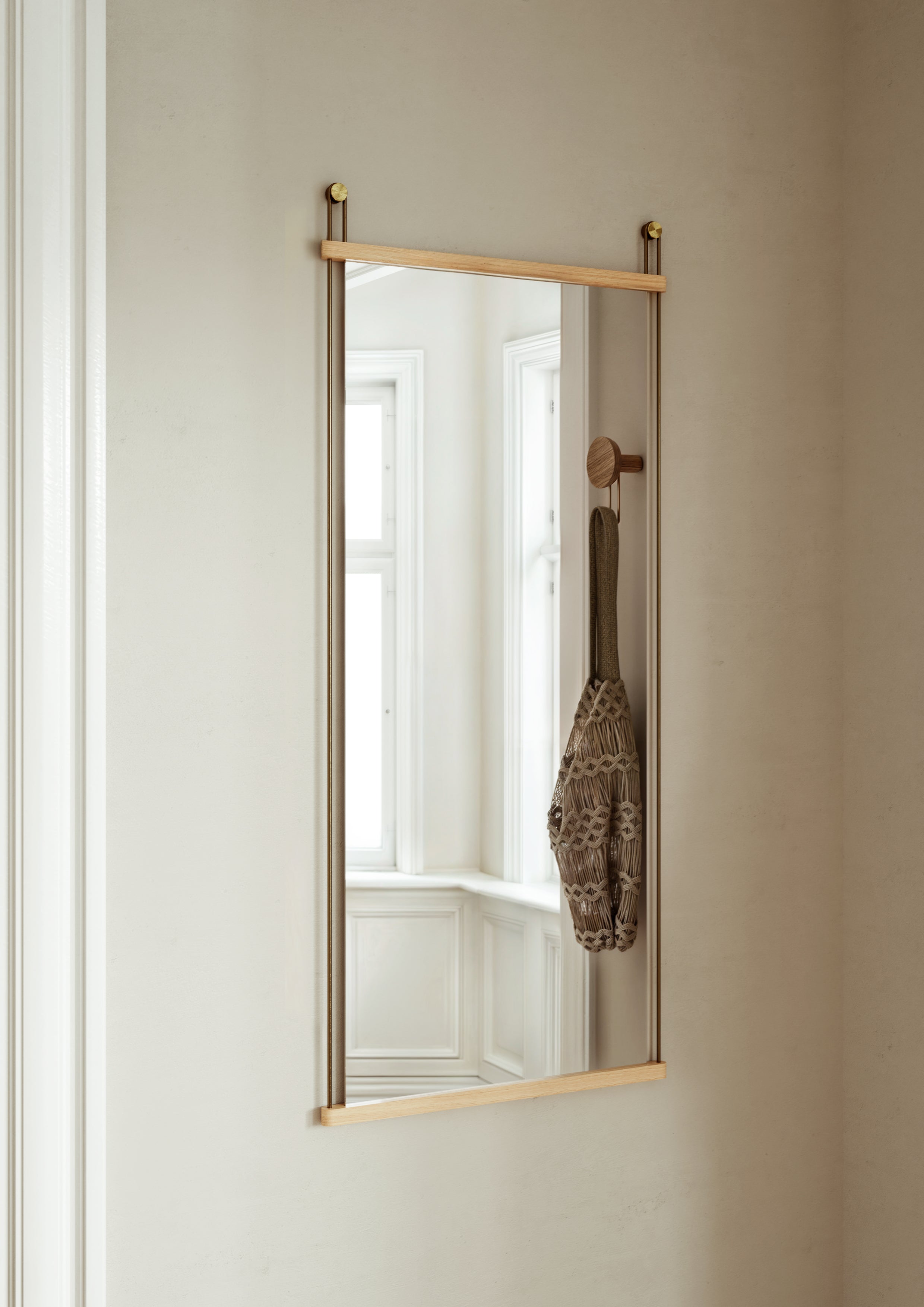 Wall mirror in Scandinavian design with horizontal oak slats and brass-plated metal bars.