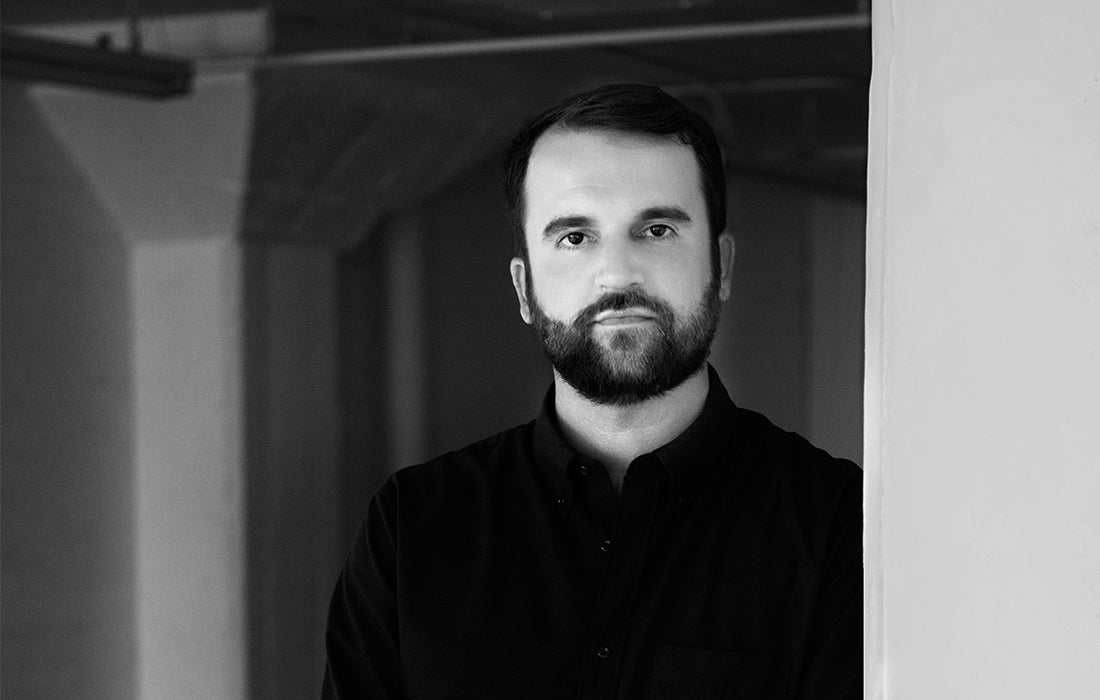 Black-and-white portrait of designer Adam Miller, founder of AD Miller.