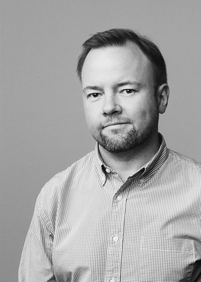 Black-and-white portrait of designer Mika Tolvanen.