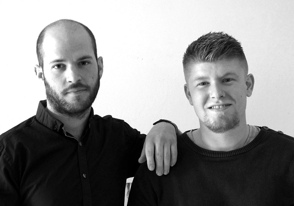 Black-and-white portrait of designers Mark Wedel and Rasmus Røpke, founders of the design studios MOAKK and Røpke Design.
