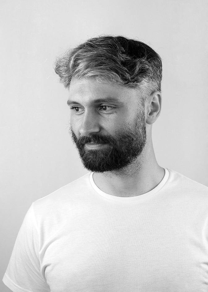 Black-and-white portrait of designer Oleg Pugachev.