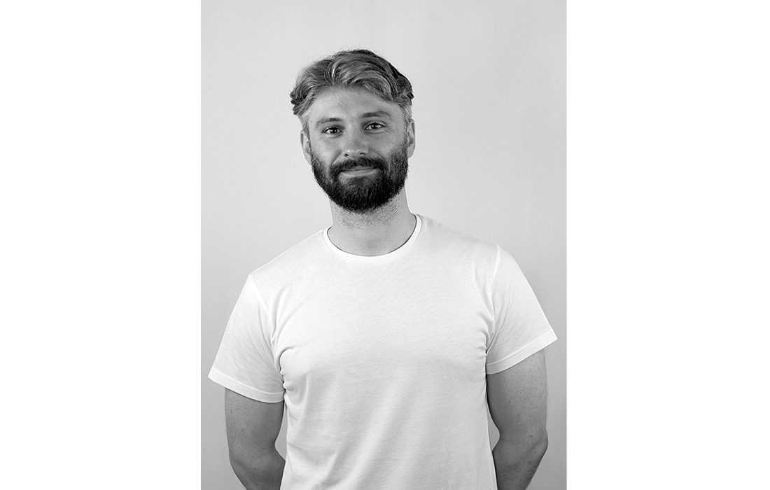 Black-and-white portrait of designer Oleg Pugachev.