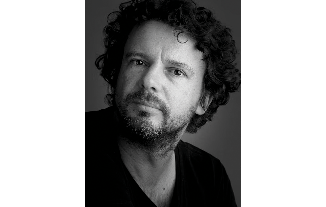 Black-and-white portrait of designer Roel Vandebeek.