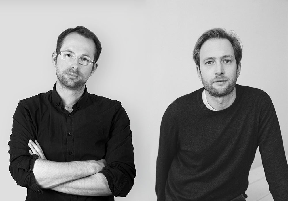 Black-and-white portrait of designers Maximilian Schmahl and Fabian Schnippering founders of the design studio Schmahl + Schnippering.