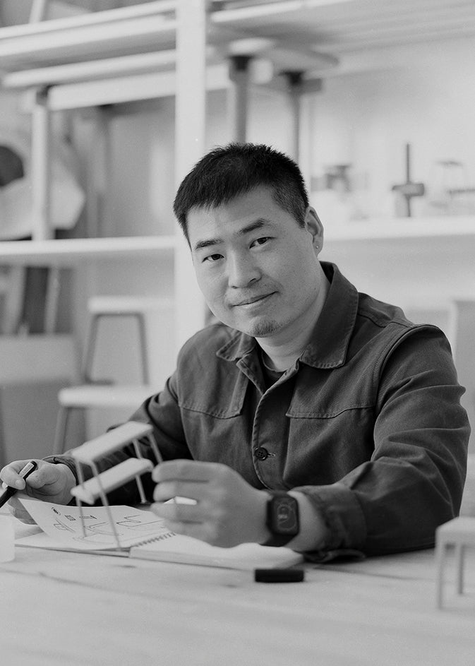 Black-and-white portrait of designer Qian Jiang, founder of Studio Dejawu.